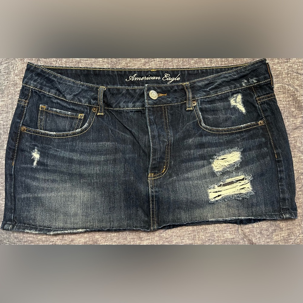 American Eagle Mini Skirt. Button fly. Distressed areas. Size 14.